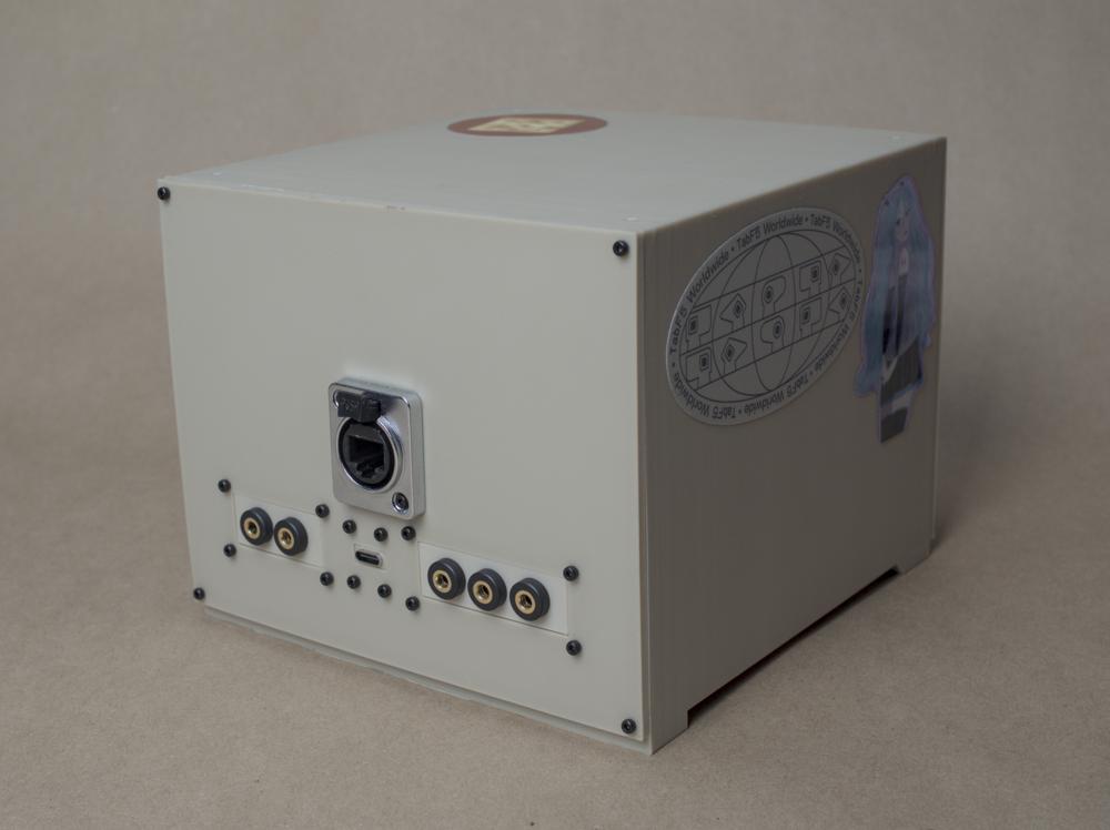 The back of the 3d printed box. It has an rj45 port, a group of 3 audio inputs, 2 outputs, and a usb-c port
